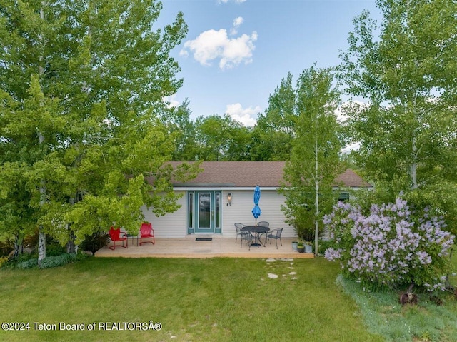 back of house featuring a yard and a patio