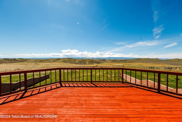 wooden terrace featuring a rural view