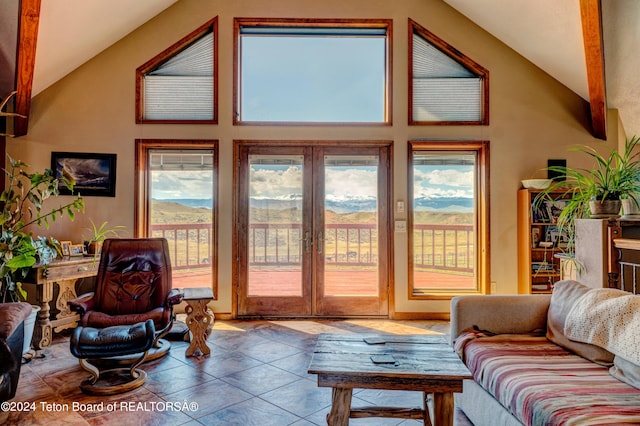 tiled living room featuring plenty of natural light and vaulted ceiling