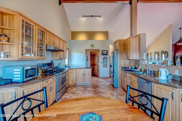 kitchen with beamed ceiling, high vaulted ceiling, light tile floors, and stainless steel appliances