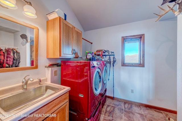 laundry area with tile flooring, sink, washing machine and clothes dryer, and cabinets