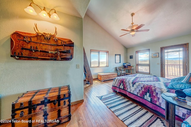 bedroom featuring ceiling fan, multiple windows, vaulted ceiling, and hardwood / wood-style flooring