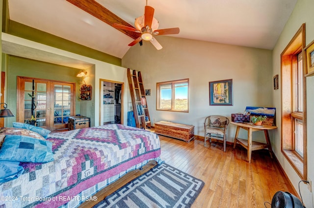 bedroom with a closet, ceiling fan, hardwood / wood-style flooring, french doors, and lofted ceiling