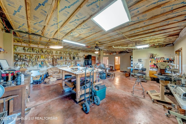 miscellaneous room featuring a workshop area, ceiling fan, and concrete flooring