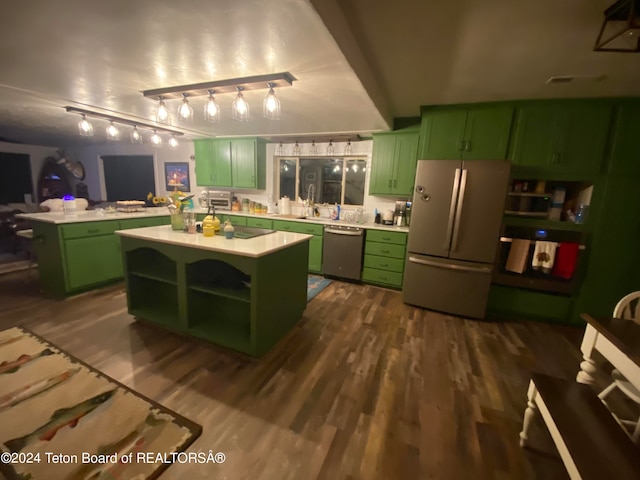 kitchen featuring green cabinets, stainless steel appliances, and a kitchen island