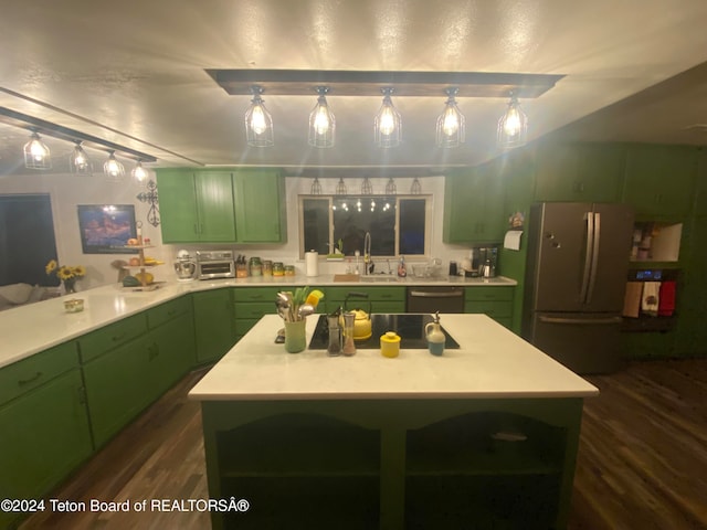 kitchen featuring dark wood-type flooring, a center island, green cabinets, and stainless steel appliances