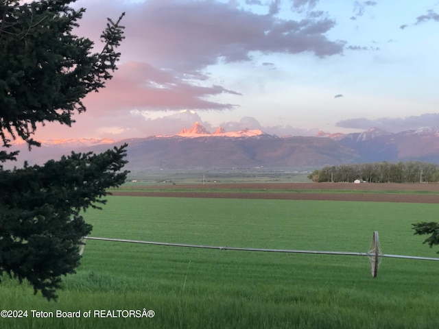 view of home's community featuring a lawn, a mountain view, and a rural view