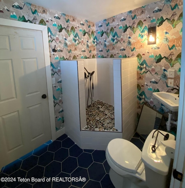 bathroom with toilet, walk in shower, and tile patterned floors