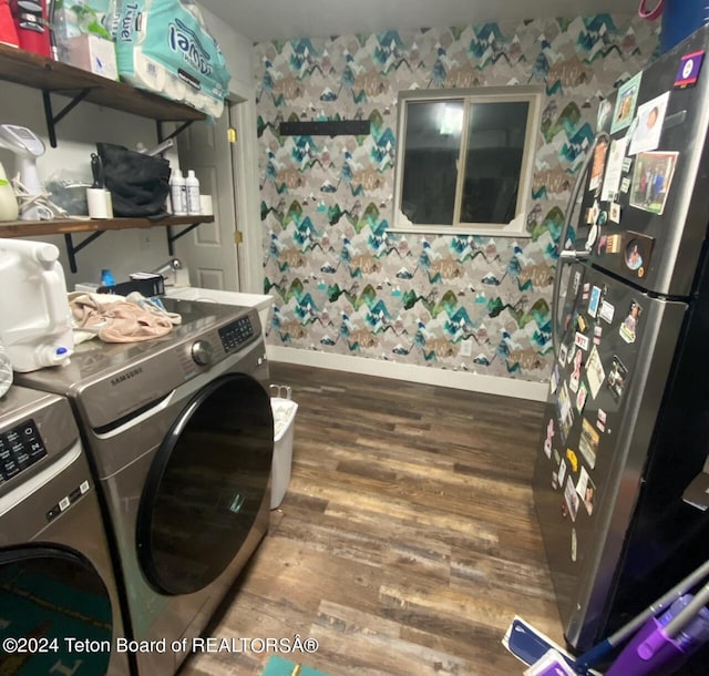 laundry room featuring sink, washing machine and clothes dryer, and hardwood / wood-style flooring