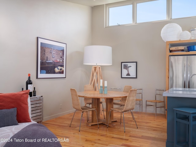 dining space with light hardwood / wood-style flooring