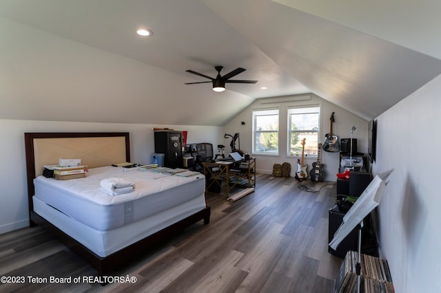 bedroom with ceiling fan, dark wood-type flooring, and vaulted ceiling