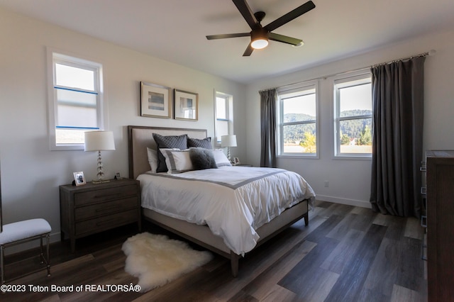 bedroom with ceiling fan and dark hardwood / wood-style flooring