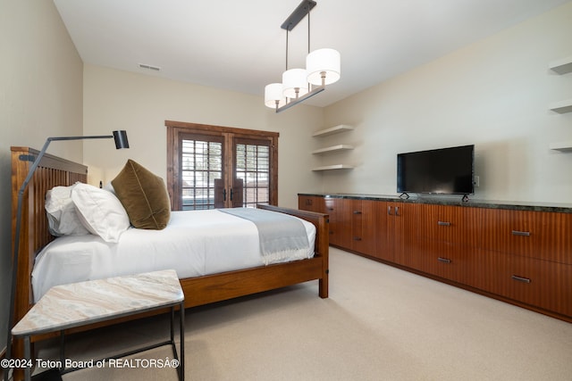 carpeted bedroom with french doors