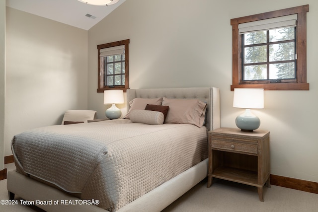 carpeted bedroom with vaulted ceiling