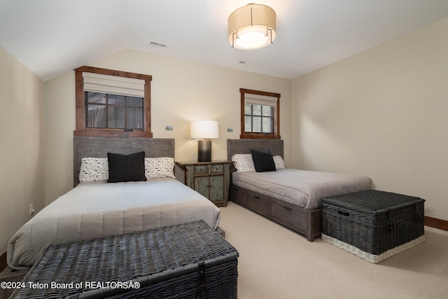 carpeted bedroom with vaulted ceiling