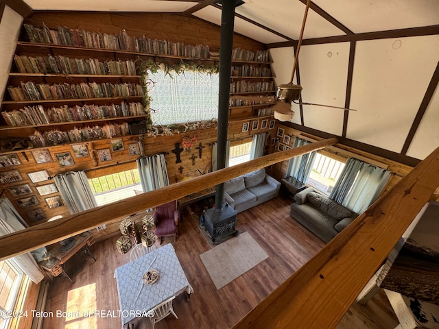 living room featuring vaulted ceiling, hardwood / wood-style floors, and built in features