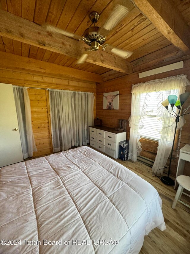 bedroom featuring wood walls, hardwood / wood-style floors, beam ceiling, and wood ceiling