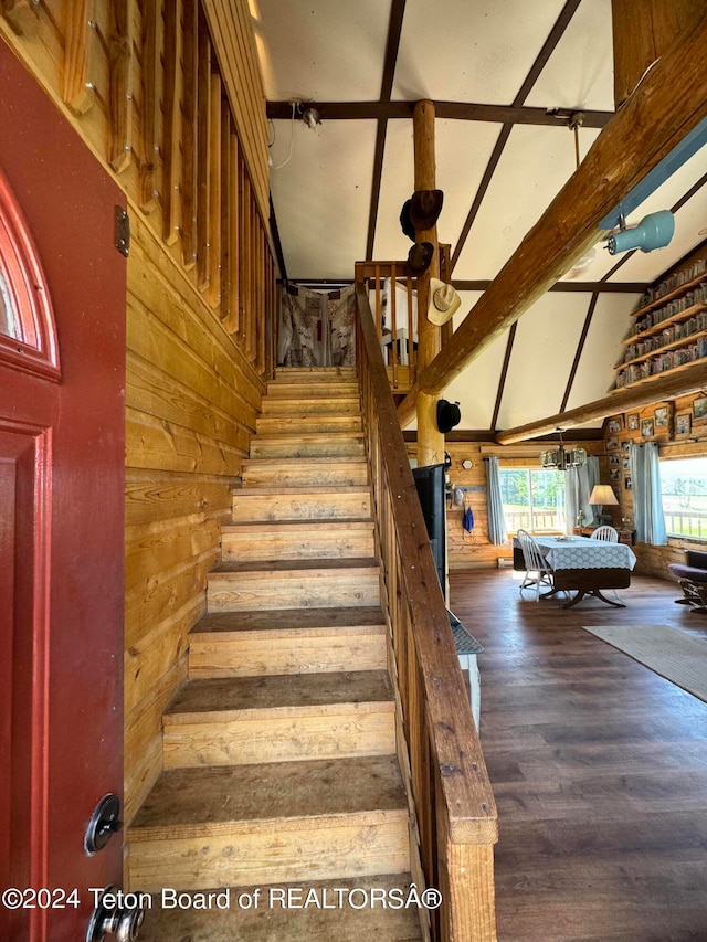 stairway featuring high vaulted ceiling, beam ceiling, and hardwood / wood-style flooring