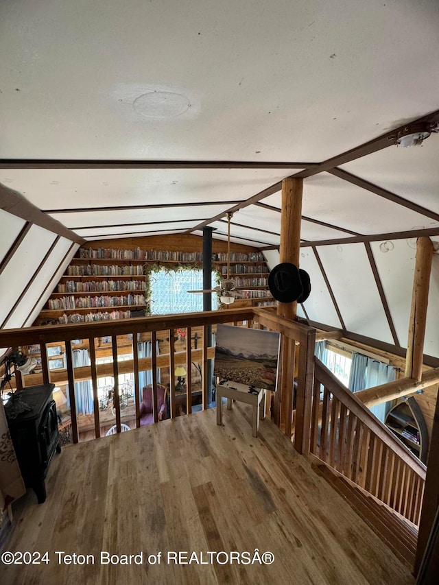 interior space featuring vaulted ceiling with beams and hardwood / wood-style floors