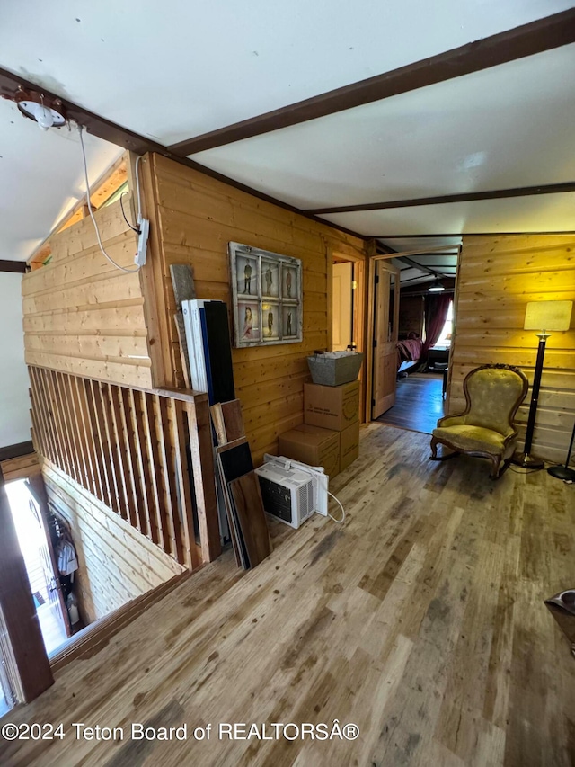 stairway featuring wood walls and hardwood / wood-style floors