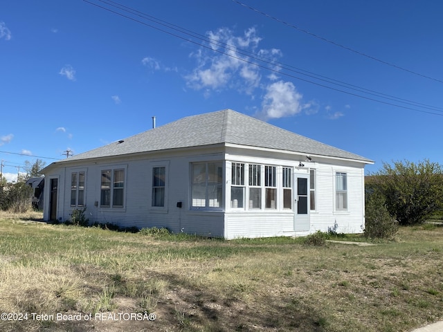 view of property exterior with a yard