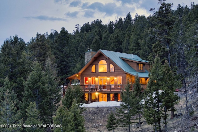 rear view of property featuring a wooden deck