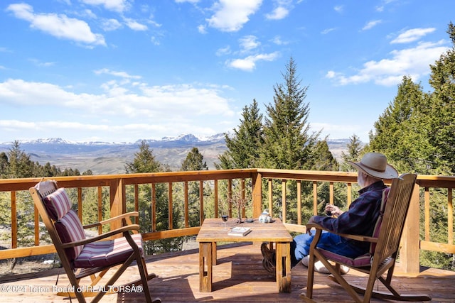 wooden deck featuring a mountain view