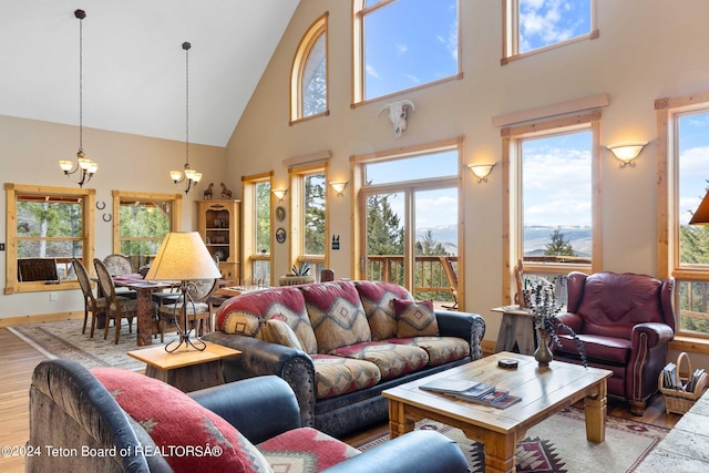 living room featuring light hardwood / wood-style floors and high vaulted ceiling