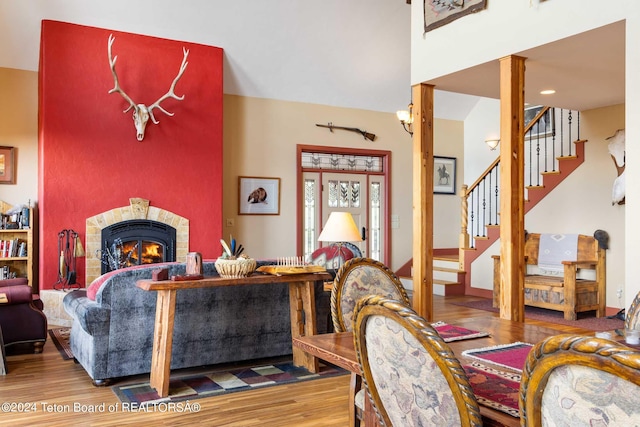 living room with a fireplace and wood-type flooring