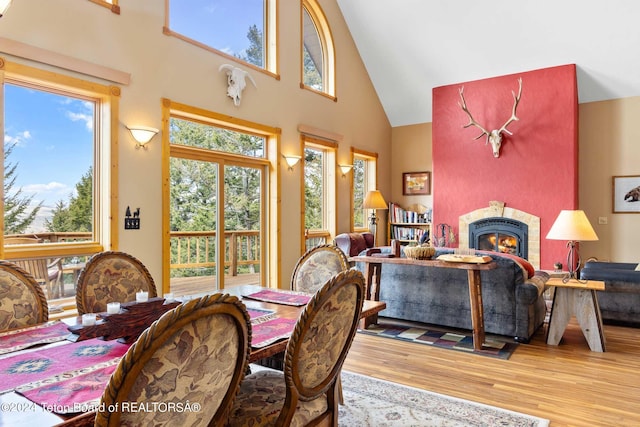 dining room with hardwood / wood-style floors and high vaulted ceiling