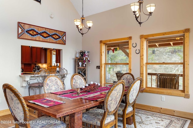 dining room with hardwood / wood-style flooring, a notable chandelier, and vaulted ceiling