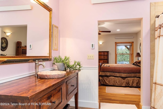 bathroom featuring ceiling fan, vanity, and wood-type flooring