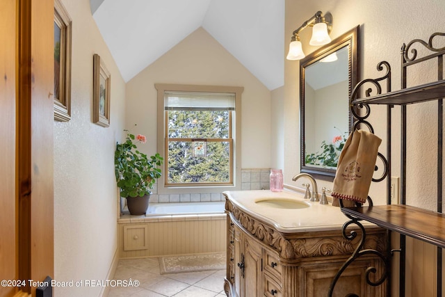 bathroom with tile patterned flooring, vanity, lofted ceiling, and a washtub