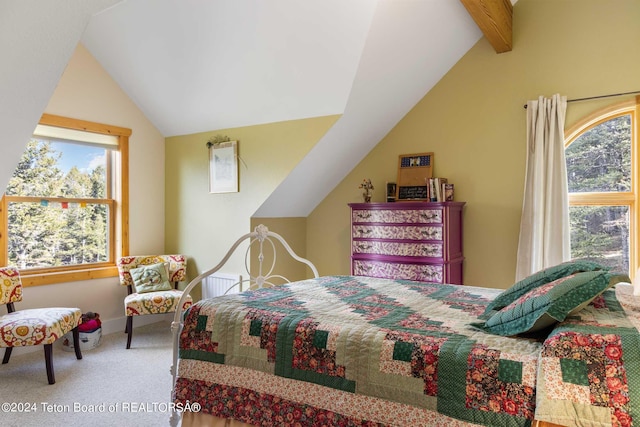 carpeted bedroom with lofted ceiling with beams