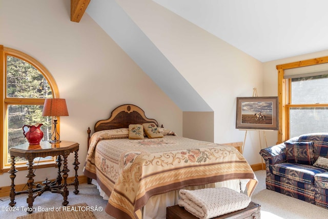 bedroom featuring carpet flooring and vaulted ceiling with beams