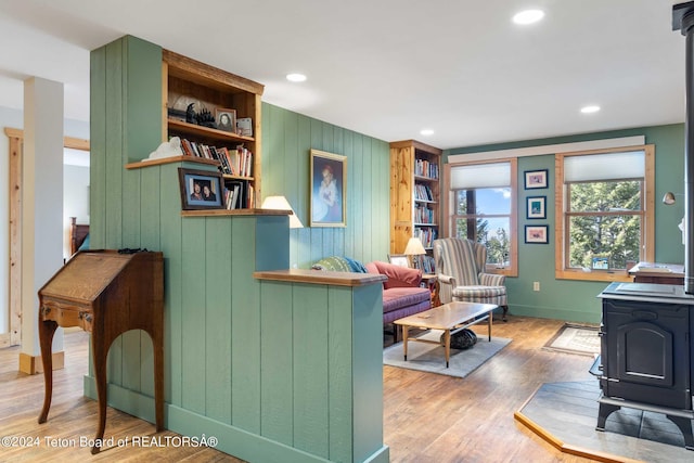 interior space with wood-type flooring and a wood stove