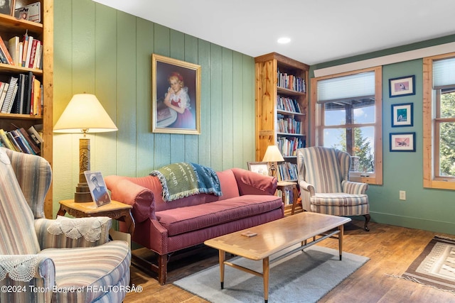 sitting room with built in features and light hardwood / wood-style floors