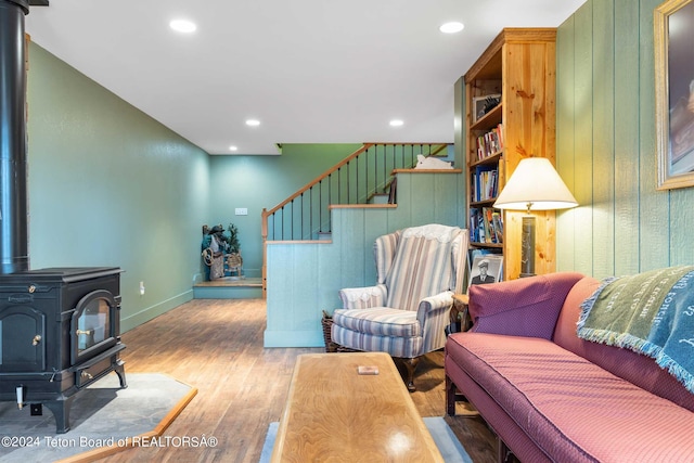 living room featuring hardwood / wood-style floors and a wood stove