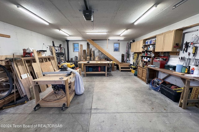 garage with a workshop area and a garage door opener