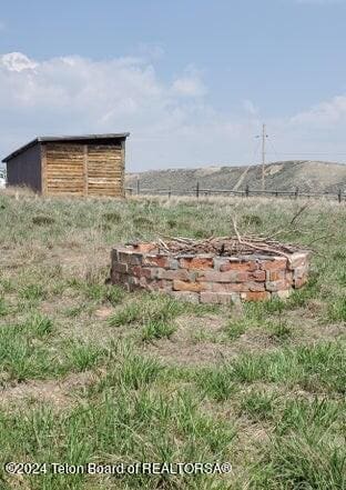 view of yard with a fire pit