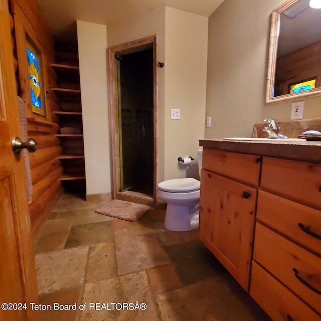 bathroom with log walls, vanity, toilet, and an enclosed shower