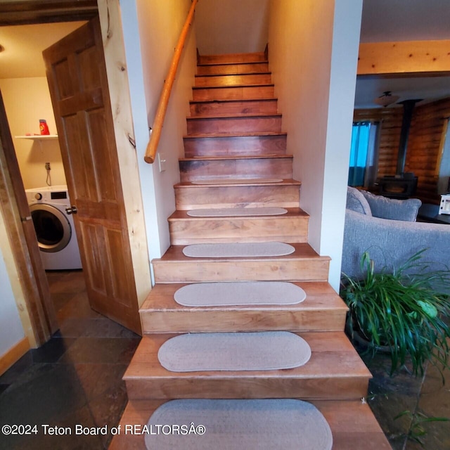 stairs with washer / dryer and a wood stove