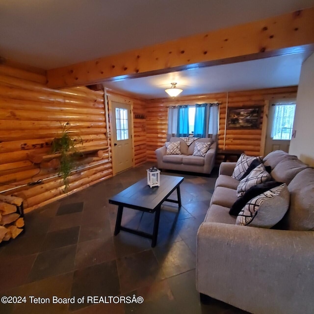 living room featuring log walls and beamed ceiling