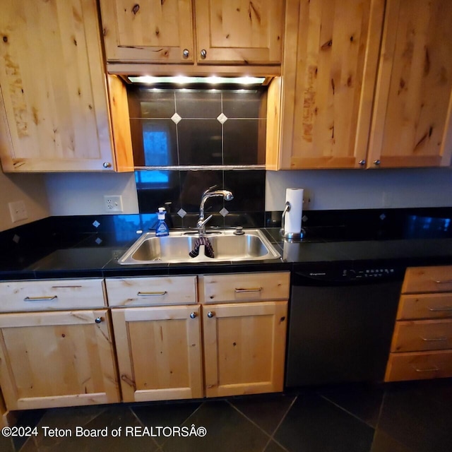 kitchen with light brown cabinetry, black dishwasher, dark tile patterned floors, and sink