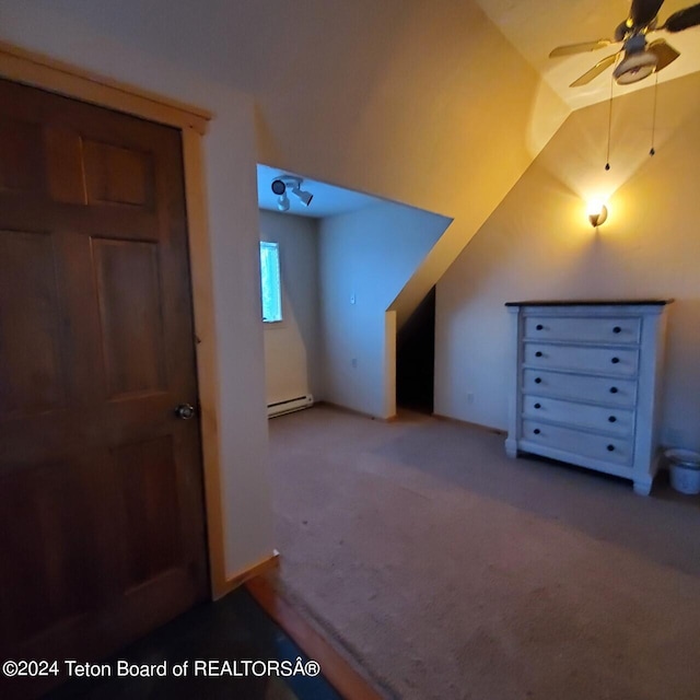 additional living space with ceiling fan, lofted ceiling, carpet floors, and a baseboard radiator