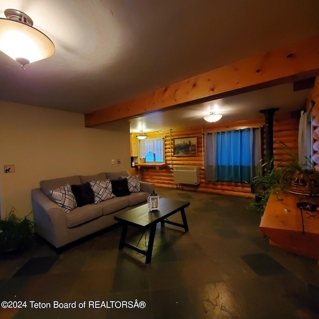 living room with beamed ceiling and rustic walls