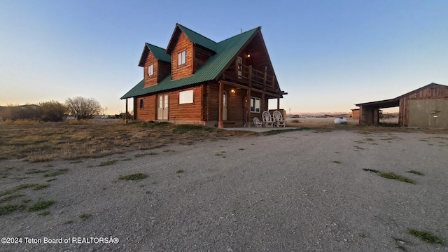 property exterior at dusk with an outdoor structure