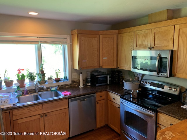 955 Budge Dr Unit 4, Jackson, WY 83001 - kitchen featuring appliances with stainless steel finishes, a sink, dark countertops, and dark wood-style floors