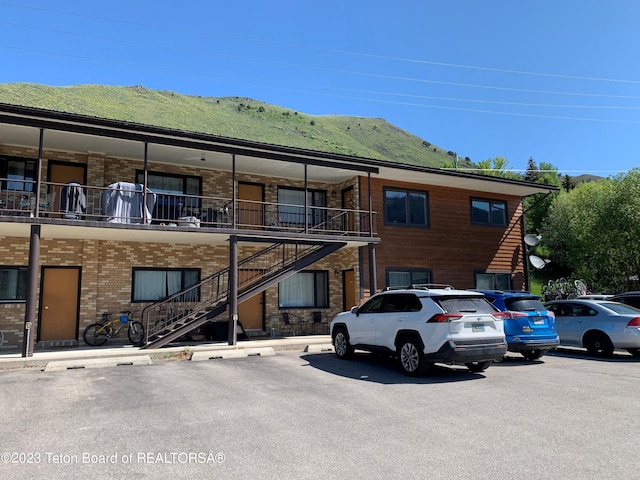 955 Budge Dr Unit 4, Jackson, WY 83001 - view of property featuring uncovered parking, a mountain view, and stairway