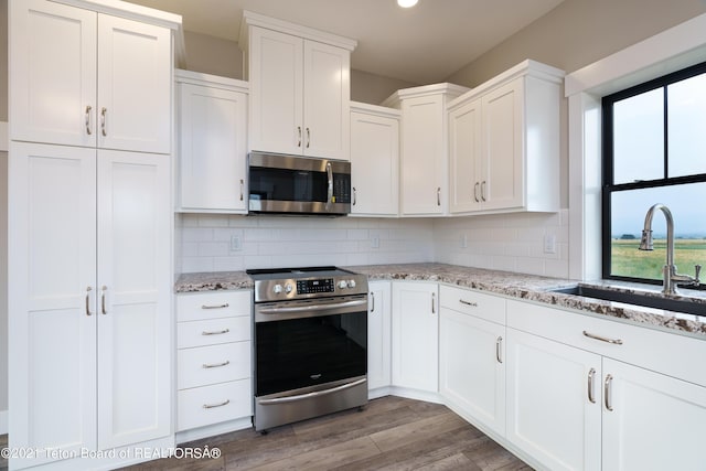 1845 S 5000 W, Driggs, ID 83422 - kitchen featuring white cabinets, a wealth of natural light, appliances with stainless steel finishes, and a sink